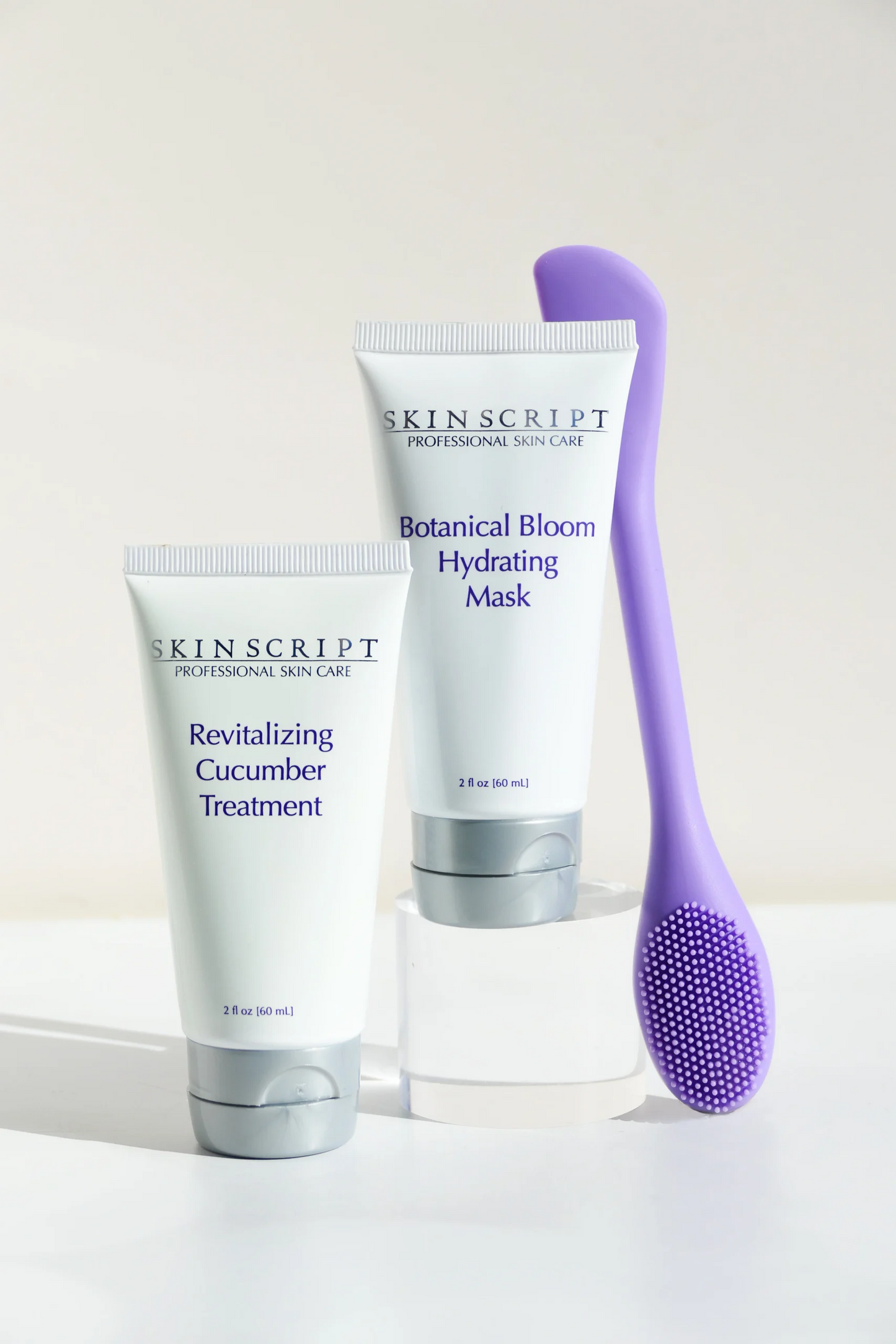 Two skincare products and a brush on a white background with 'Skinscript' branding.