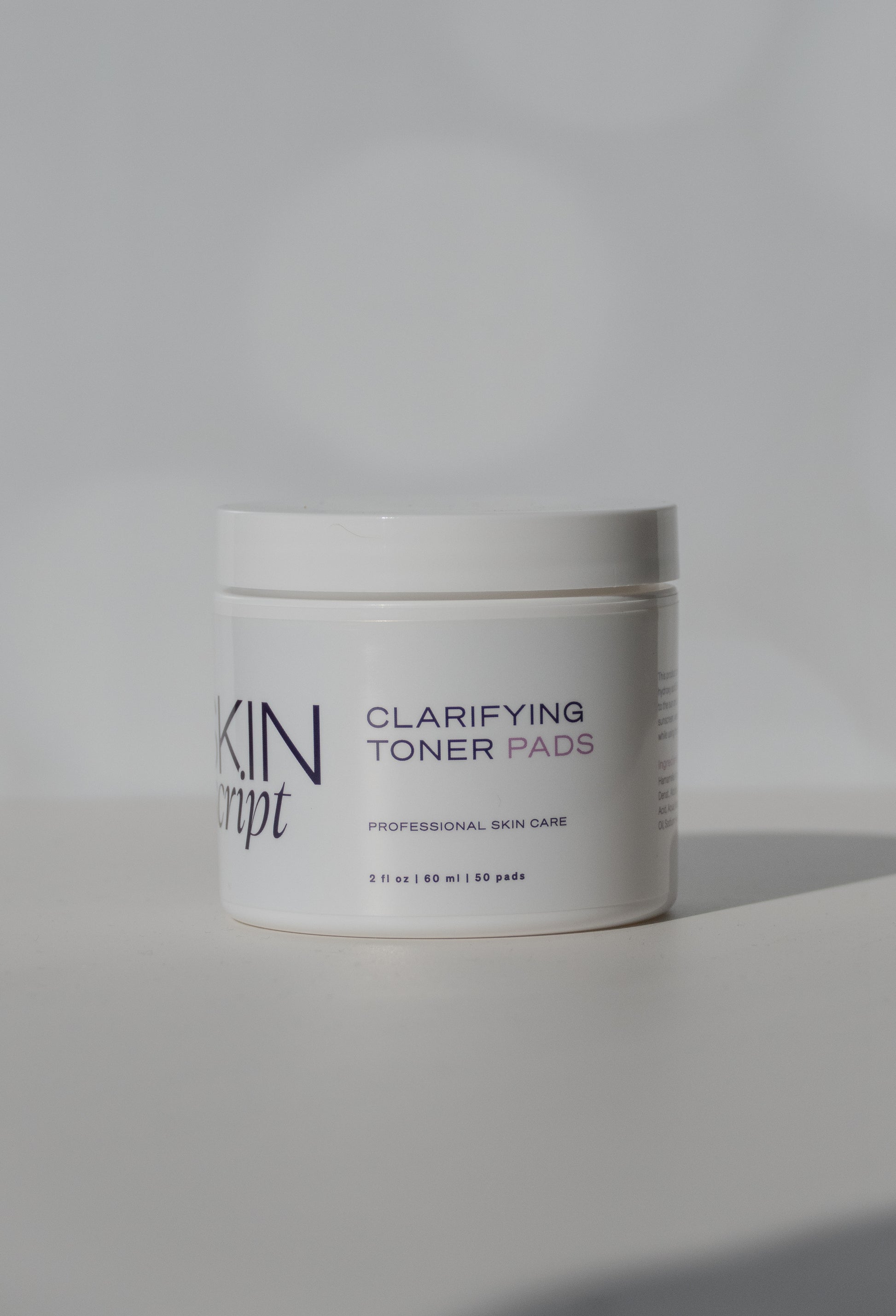 Jar of Skin Script Clarifying Toner Pads on a light gray background