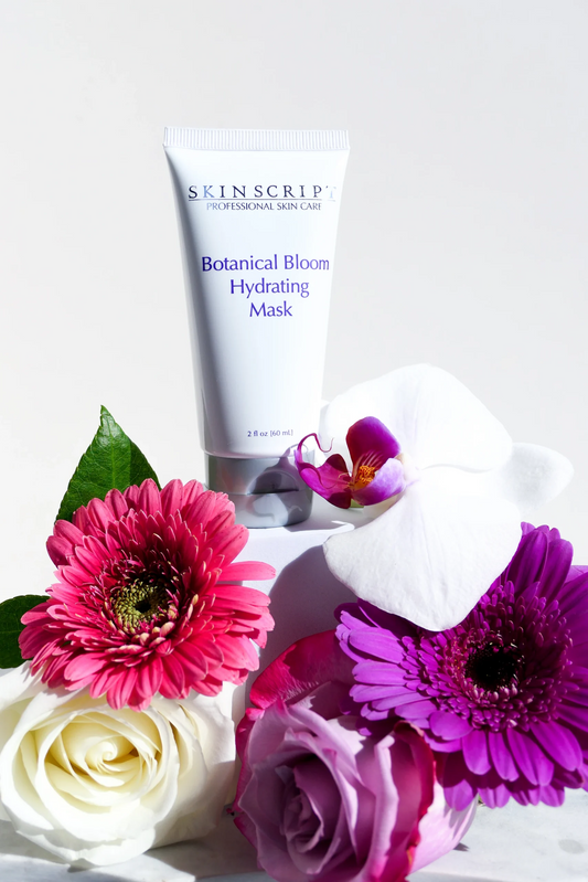 Skincare product with flowers on a white background Skincare mask tube labeled 'Botanical Bloom Hydrating Mask' by Skin script on a white background